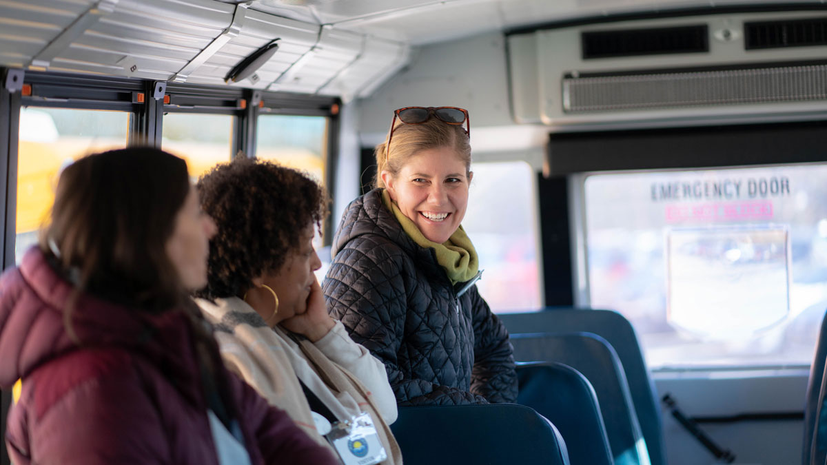 Three women sitting on a bus